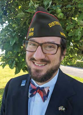 Jesse Atkins in a military cap and bowtie