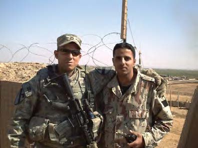 Thomas Renteria in fatigues with arm around a fellow soldier